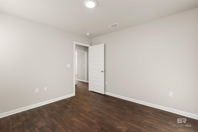 unfurnished room with dark hardwood / wood-style flooring