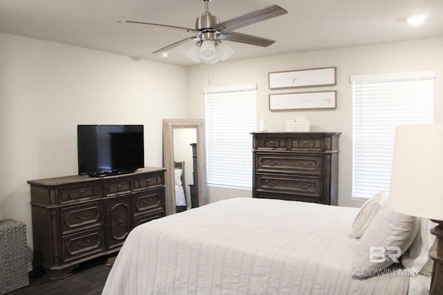 bedroom with ceiling fan and dark wood-type flooring