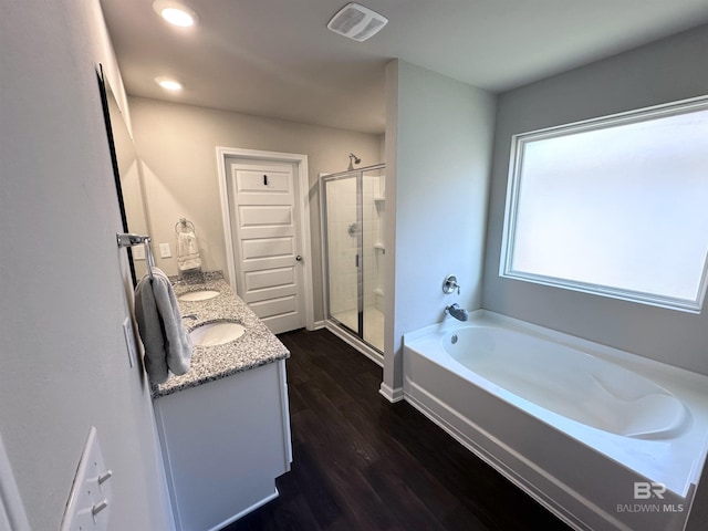 bathroom with hardwood / wood-style flooring, vanity, and separate shower and tub