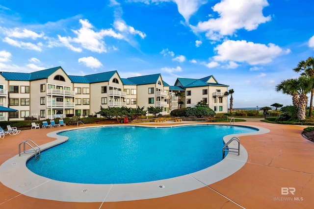 view of swimming pool featuring a patio area