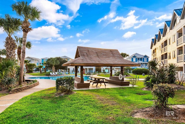 surrounding community with a gazebo, a swimming pool, and a lawn