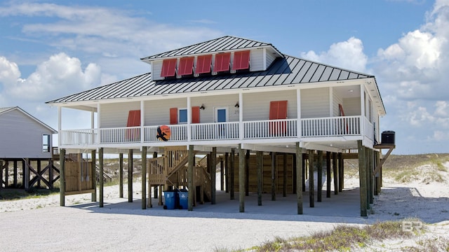 coastal home with a carport, central AC unit, and covered porch