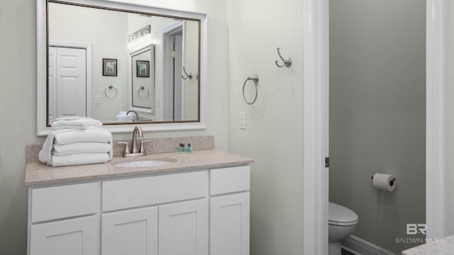 bathroom featuring vanity and toilet