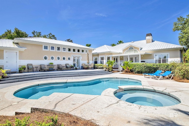 view of swimming pool featuring an in ground hot tub, a patio, and french doors