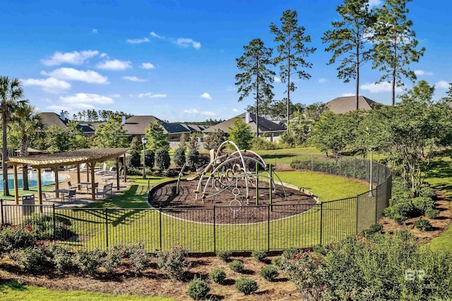 view of playground featuring a lawn and a pergola