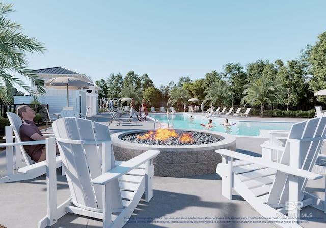 view of pool with a patio area and a fire pit