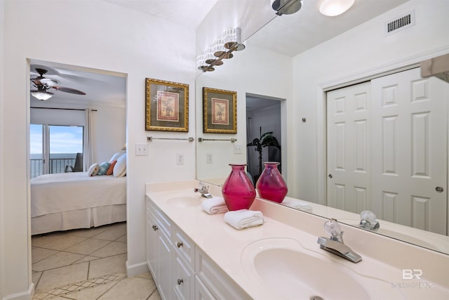 bathroom with ensuite bathroom, tile patterned flooring, double vanity, and ceiling fan