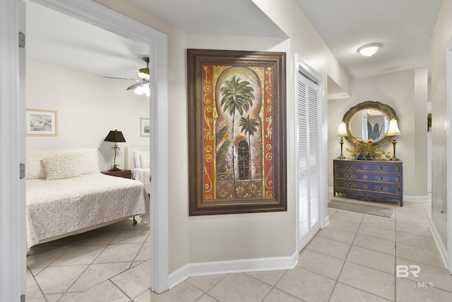bedroom featuring light tile patterned flooring and baseboards