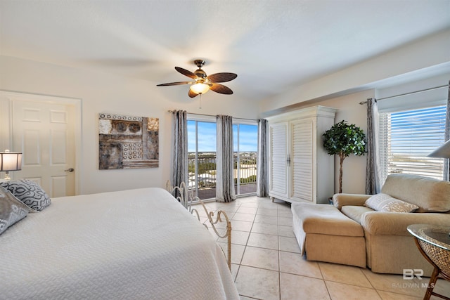 bedroom featuring access to outside, light tile patterned floors, and ceiling fan