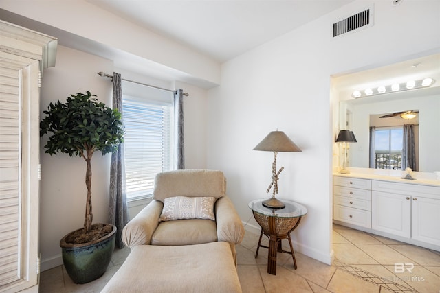 sitting room with light tile patterned floors and baseboards