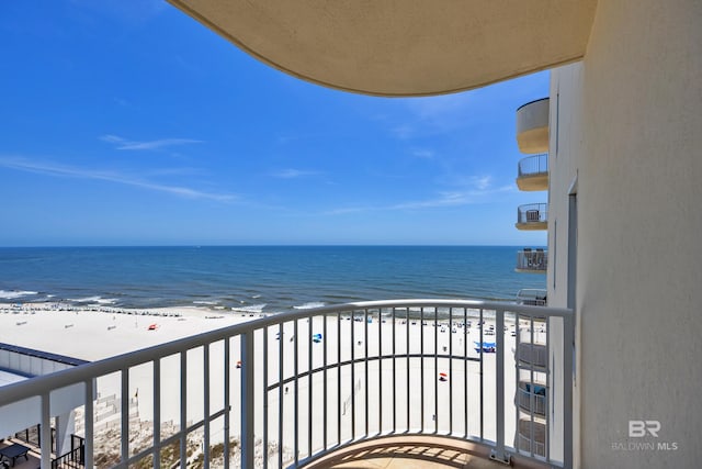 balcony featuring view of water and beach