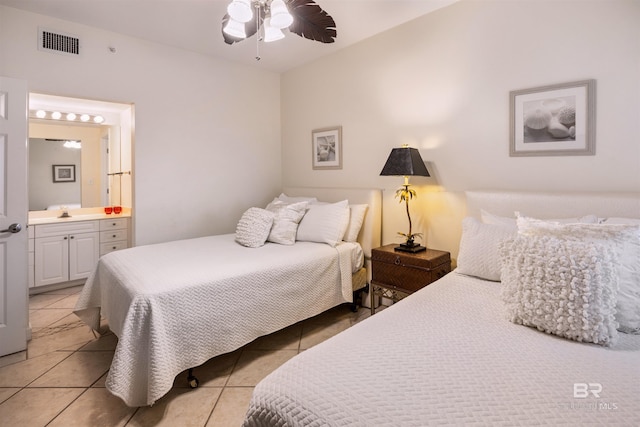 bedroom featuring light tile patterned flooring and connected bathroom