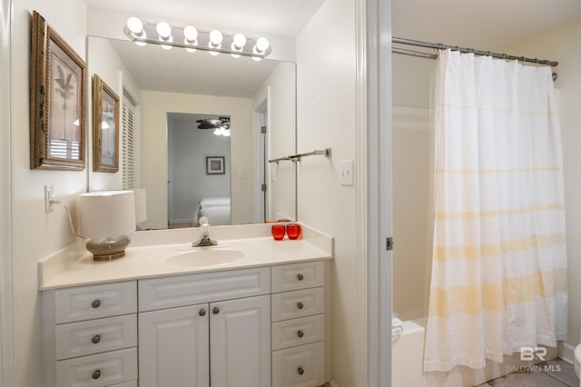 full bathroom with vanity, shower / tub combo with curtain, and toilet