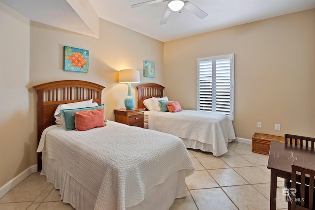 bedroom featuring light tile patterned floors, baseboards, and a ceiling fan