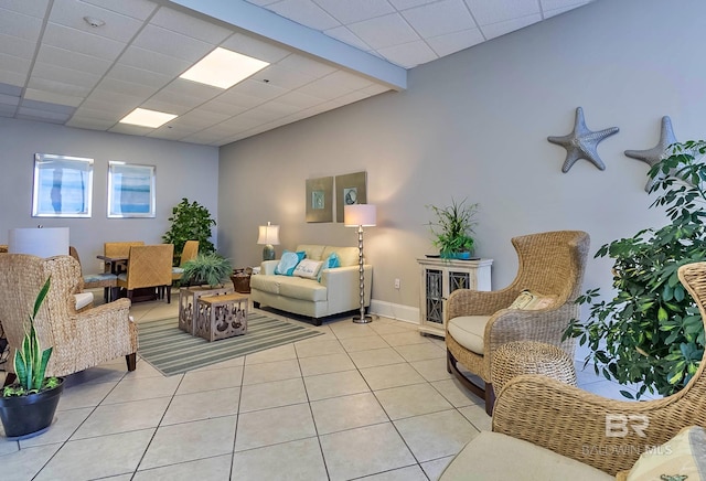 living area featuring light tile patterned flooring and baseboards