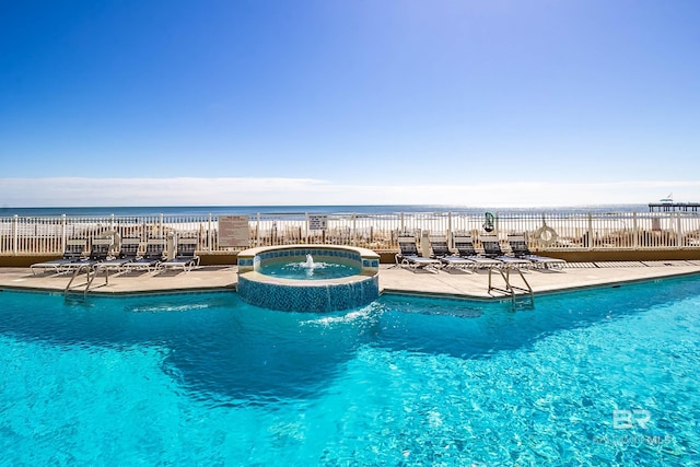 view of pool with a pool with connected hot tub and a patio area
