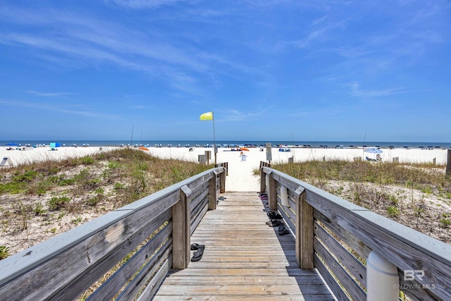surrounding community with view of water and beach