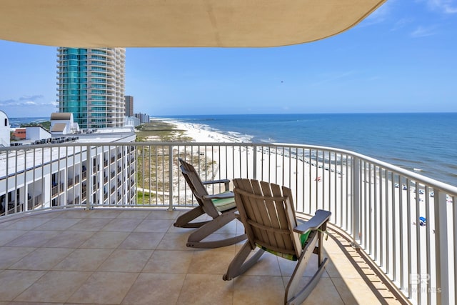 balcony with view of water and beach