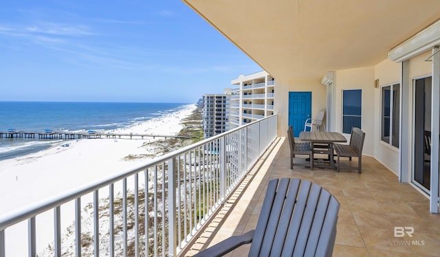 balcony featuring view of water and beach