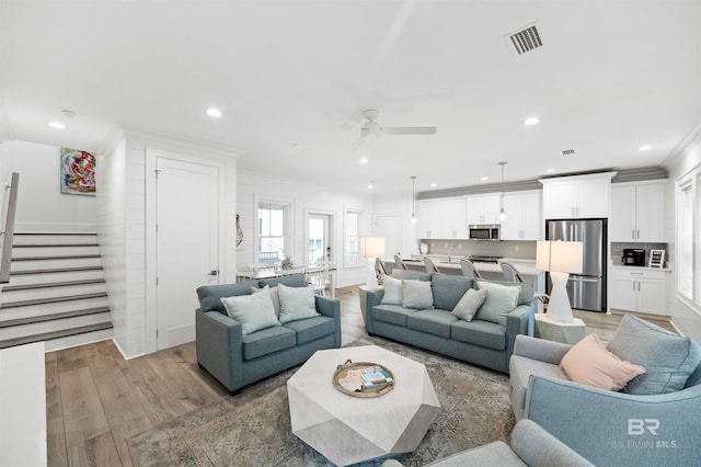 1476 Sandpiper Ln Unit B, Gulf Shores, AL 36542 - living room featuring ornamental molding, stairs, light wood finished floors, ceiling fan, and recessed lighting