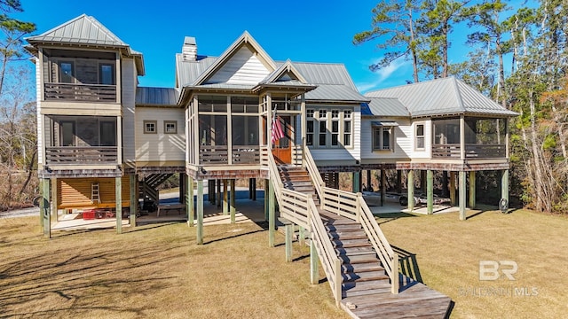 view of jungle gym featuring a patio area, a sunroom, and a lawn