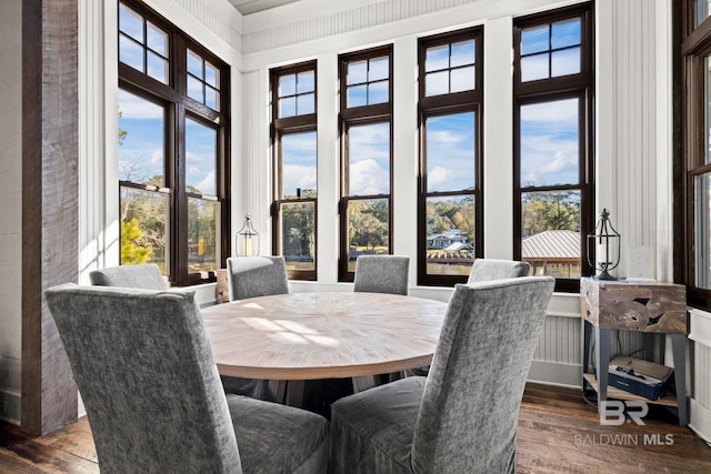 dining area featuring dark wood-type flooring and plenty of natural light