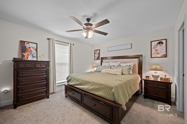 bedroom with ceiling fan, baseboards, and light colored carpet