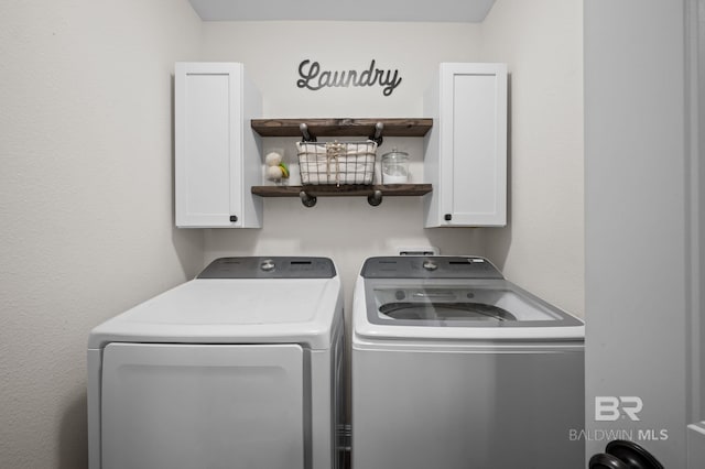 laundry area featuring cabinet space and washing machine and clothes dryer