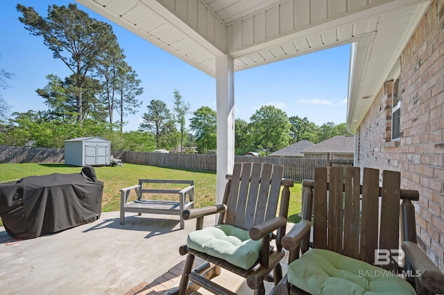 view of patio / terrace with grilling area, a shed, and a fenced backyard