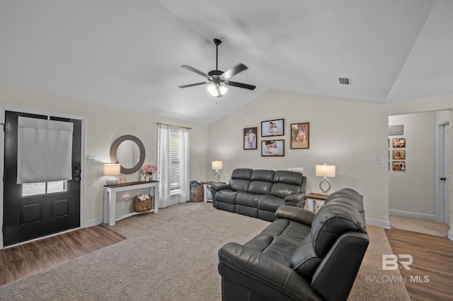 carpeted living room featuring lofted ceiling, visible vents, a ceiling fan, and baseboards