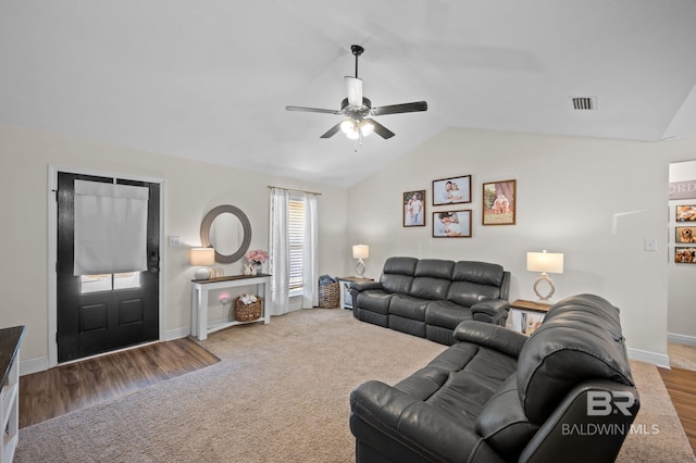 living room with lofted ceiling, visible vents, a ceiling fan, carpet floors, and baseboards