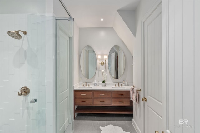 bathroom featuring walk in shower, vanity with extensive cabinet space, double sink, and tile floors