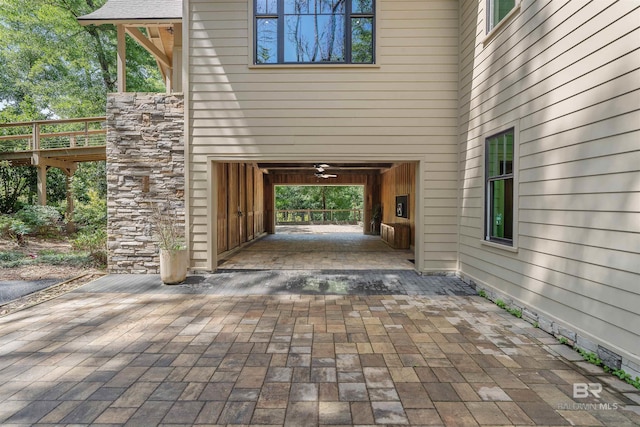 property entrance with ceiling fan and a patio