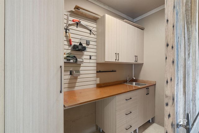 office area with crown molding and sink