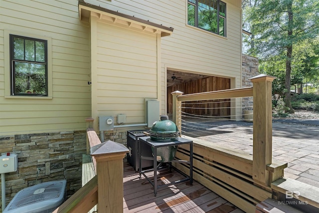 wooden terrace featuring central AC unit