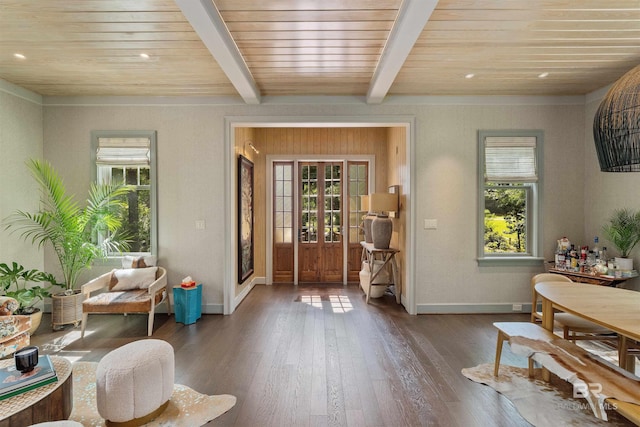 entryway with a wealth of natural light, beamed ceiling, dark hardwood / wood-style floors, and wooden ceiling