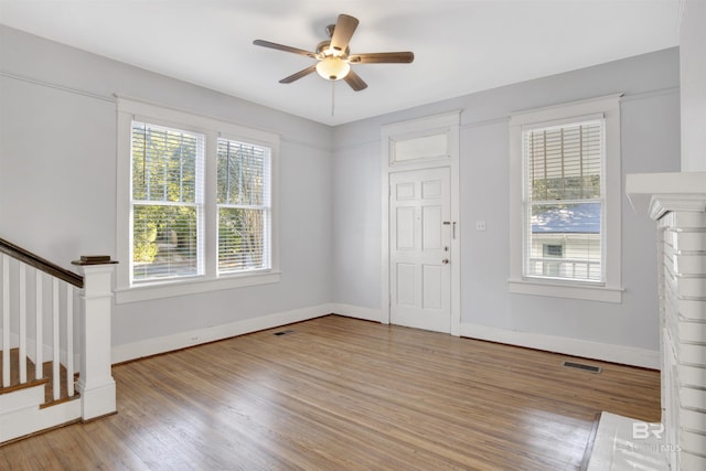 foyer entrance with hardwood / wood-style floors and ceiling fan