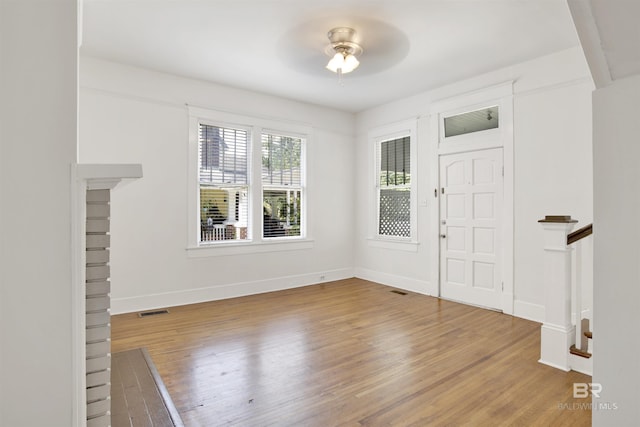 foyer with hardwood / wood-style floors and ceiling fan