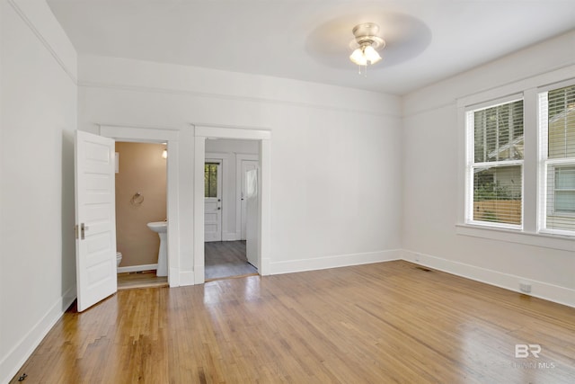 unfurnished room with hardwood / wood-style flooring and ceiling fan