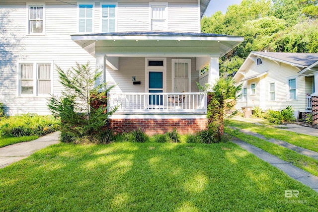 view of front of house featuring a front yard and a porch