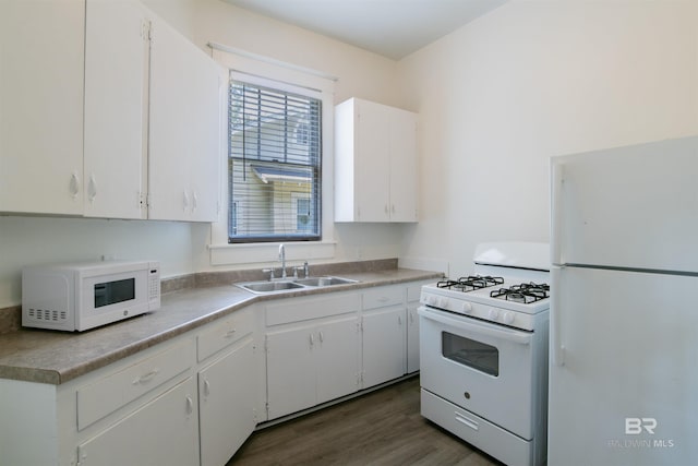 kitchen with white cabinetry, sink, white appliances, and dark hardwood / wood-style floors