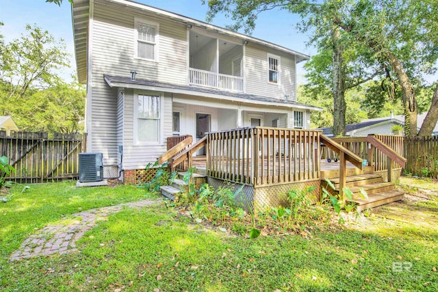 back of property with central AC, a lawn, and a deck