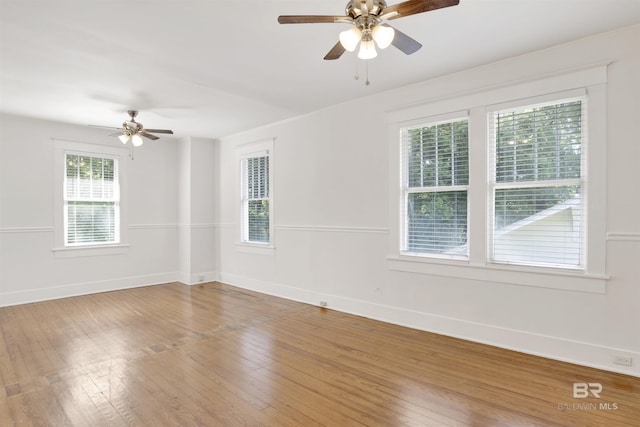 spare room with hardwood / wood-style floors and ceiling fan