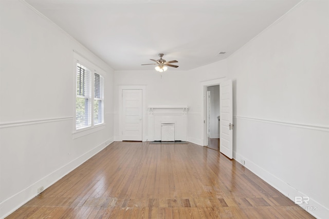 unfurnished living room featuring wood-type flooring and ceiling fan