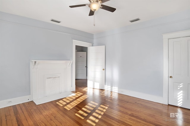 empty room featuring ceiling fan and hardwood / wood-style floors