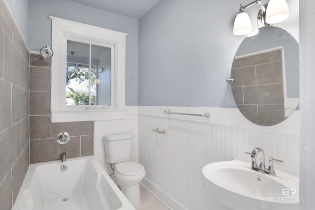 full bathroom featuring sink, tub / shower combination, and toilet