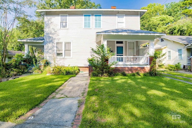 view of front of property with a porch and a front lawn