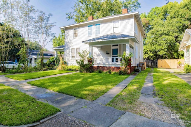 view of front of property featuring a front yard and covered porch