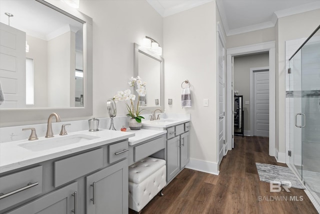 bathroom featuring vanity, crown molding, hardwood / wood-style flooring, and an enclosed shower