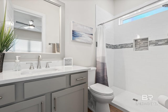 bathroom featuring vanity, toilet, a wealth of natural light, and curtained shower